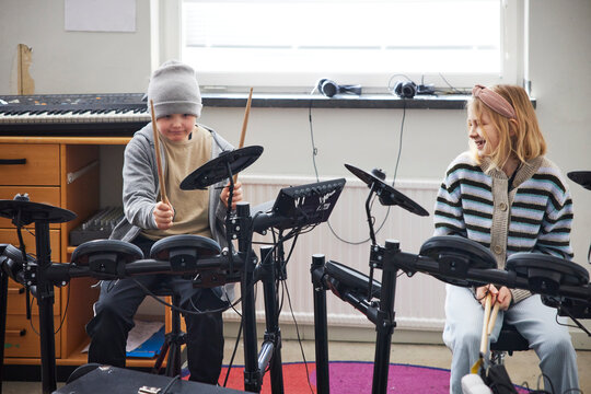 Children playing drums at school