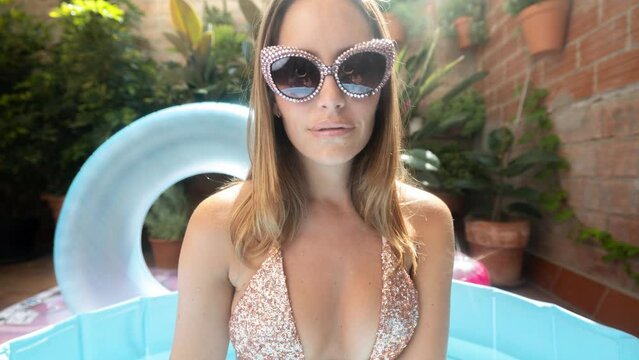 Bikini woman posing in pool