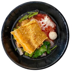 Yentafo noodles in a black bowl on a white background