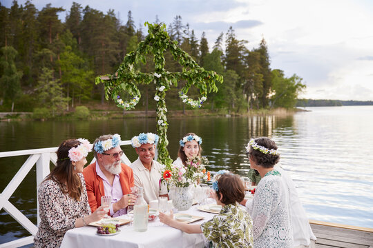 Family having midsummer dinner by lake