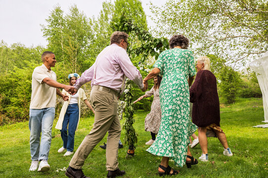People dancing around midsummer maypole