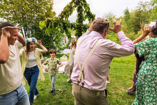 People dancing around midsummer maypole