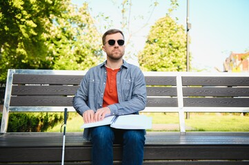 blind man sitting on a bench
