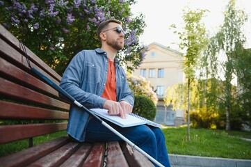 Blinded man reading by touching braille book