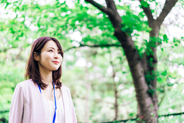 Business woman refreshing herself outside