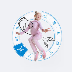 Creative portrait of happy little girl with drawing of zodiac signs isolated on light background...