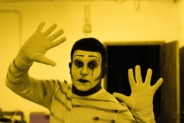 Mime performing trapped and framed in his show in his lab 