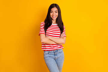 Photo of cool charming young lady wear red clothes arms folded smiling isolated yellow color background