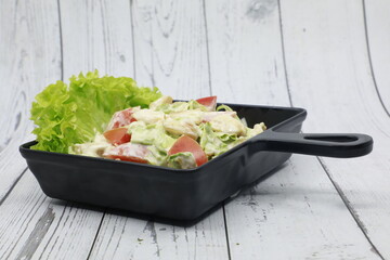 Caesar salad is a green salad of romaine lettuce and croutons dressed with lemon juice,