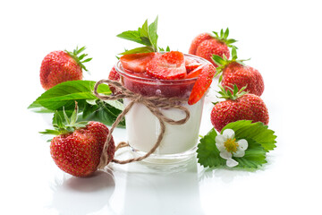 sweet homemade yogurt with strawberry jam and fresh strawberries in a glass cup