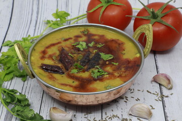 Indian popular food Dal Tadka Curry wooden background