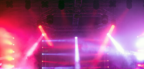 Spot lights on the stage during night concert in summer