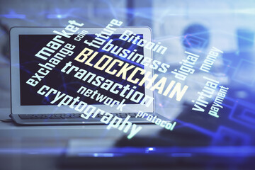 Multi exposure of blockchain and crypto economy theme hologram and table with computer background. Concept of bitcoin cryptocurrency.