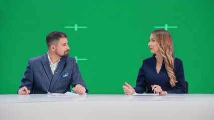 Fototapeta na wymiar Newsroom TV Studio Live News Program: Caucasian Male and Female Presenters Reporting, Green Screen Chroma Key Screen Picture. Television Cable Channel Anchor Talks, Listens. Network Broadcast Mock-up