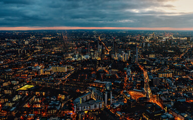 Aerial view of south west London, blue hour just after sunset, orange yellow street lights starting...