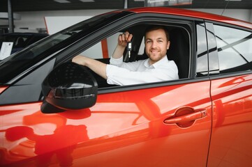 Man adult customer male buyer client chooses auto wants to buy new automobile touch check car in...