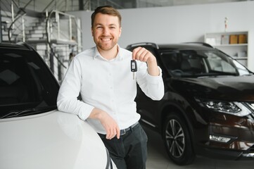 Fototapeta na wymiar Man buying a car at a showroom