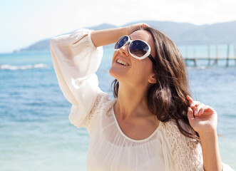 Young woman with sunglasses on summer beach