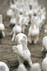 White rabbit statues made of plaster close up, outdoor art exhibition, artificial white hares