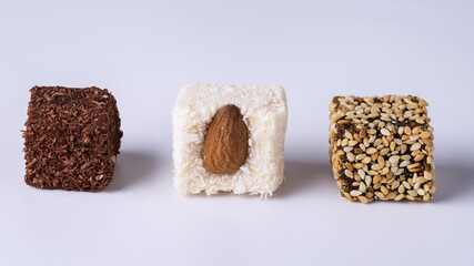 Variety of Rahat Lokum with Almond Seeds and Chocolate on Blue Background Long Assorted Traditional Eastern Desserts Arabian Sweets Turkish Delight