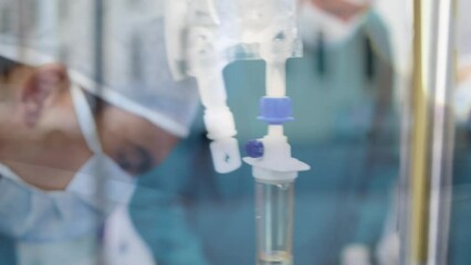 Animation of road traffic over caucasian female and male surgeons during operation - Powered by Adobe