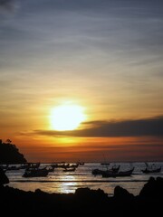 sunset over the sea at traditional fishing village