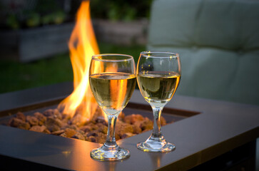 Glasse of White Wine with an Outdoor Fire in the Backyard
