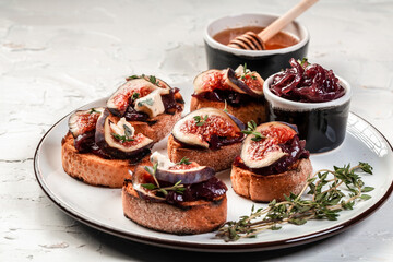 Set Bruschettas with figs and goat cheese, Blue cheese and nuts, onion jam, fresh thyme, honey on grilled crusty bread, tasty appetizer wine, banner, catering menu recipe
