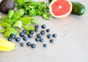 Healthy food: fruit, vegetable, superfood, leaf vegetable on gray concrete background