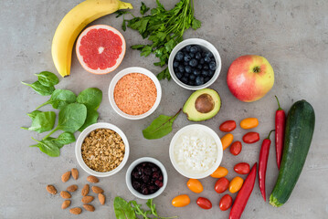 Healthy food: fruit, vegetable, superfood, leaf vegetable on gray concrete background