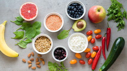 Healthy food: fruit, vegetable, superfood, leaf vegetable on gray concrete background