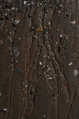 Close up shot of a sand and small pebble beach background