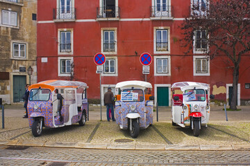 Popular tuk tuk vehicles at a parking place in Alfama in Lisbon