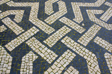 Traditional pattern cobblestone pavement (calada portuguesa) in Lisbon, Portugal