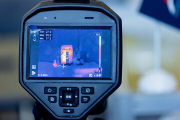 Worker use thermal IR imaging camera to check temperature for industrial work