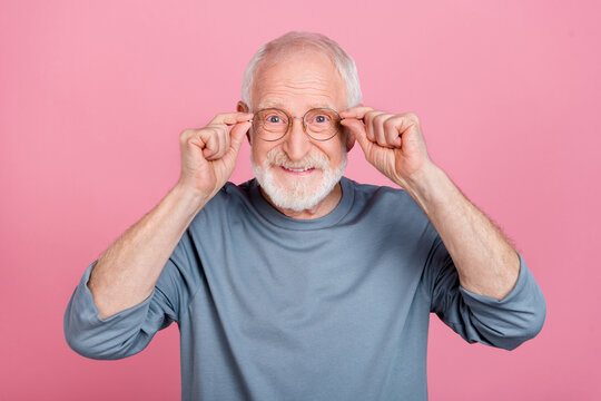 Photo of elder grey hairdo man hands eyewear wear blue shirt isolated on pink color background