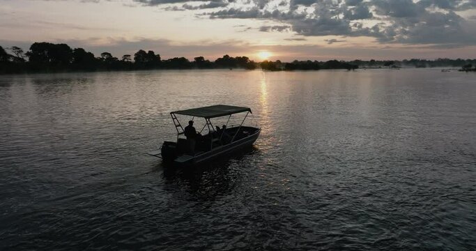 Aerial sunset view of a tourist boat sightseeing on the Zambezi River