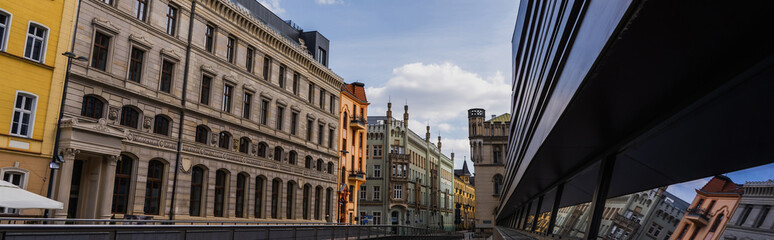 Fototapeta premium Buildings on urban street at daytime in Wroclaw, banner