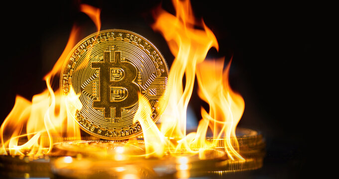 Burn the golden bitcoin coin sits on a stack of cryptocurrencies