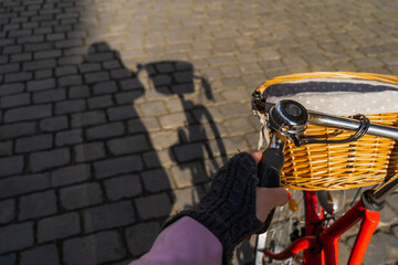 Cropped view of woman cycling on urban street in Wroclaw