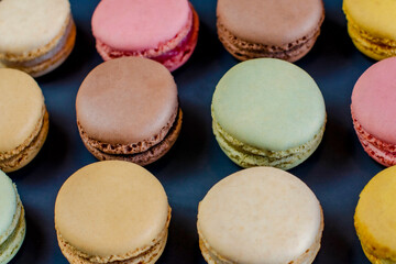 Row of delicious colorful French macaroons of different flavors, background, panoramic shot. High quality photo