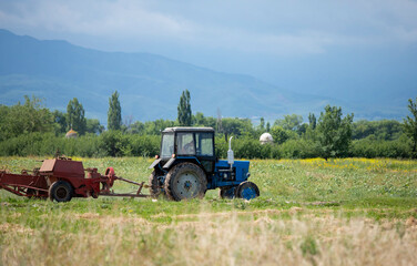 An old soviet tractor working in a field in Kyrgyzstan.