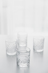 crystal glass with clean water on tabletop on white background with copy space.