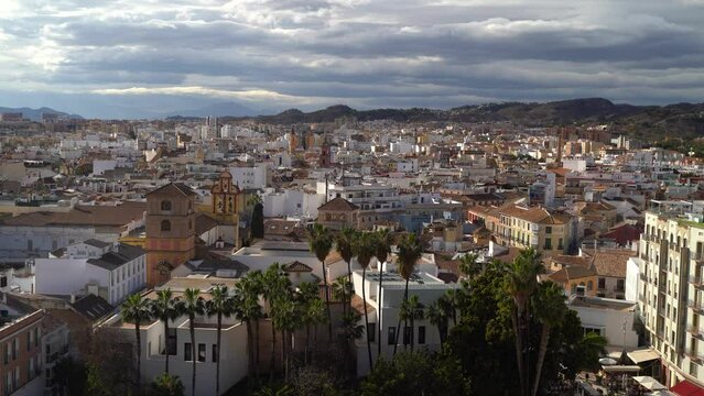 Stunning panorama view over Malaga city with palm trees and church