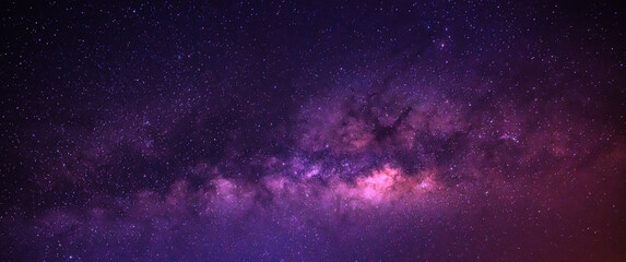 Milky way in the night sky and stars on dark background with noise and grain. Photo taken with long...