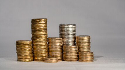 Piled up euro coins. Stacked one euro, two euro and fifty cent coins. European currency. 
