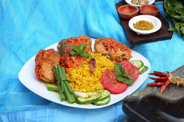 Fried fish in tomato sauce with basmati rice. Indian food