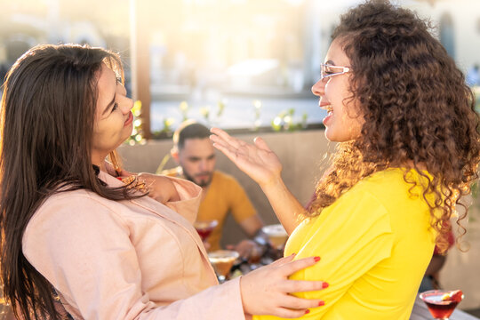 Two friends hugging outside the bar for meeting again after so long - - Together again