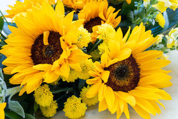 Summer festive bouquet with decorative yellow sunflowers
