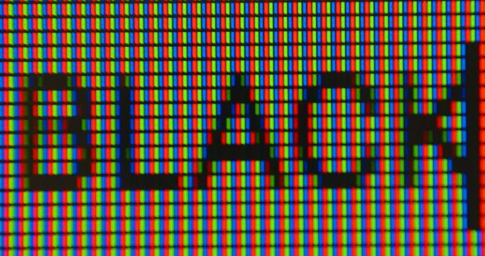 Writing The Word BLACK On A Pixelated Monitor Screen In Macro. Cursor Blinking, Letters Appearing. LCD Squares Of The Display Matrix.